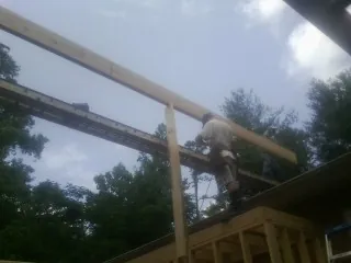 Carpenter setting a ridge beam over a new addition frame — Ice Dam Removal by Roofing Brothers in North Sioux City